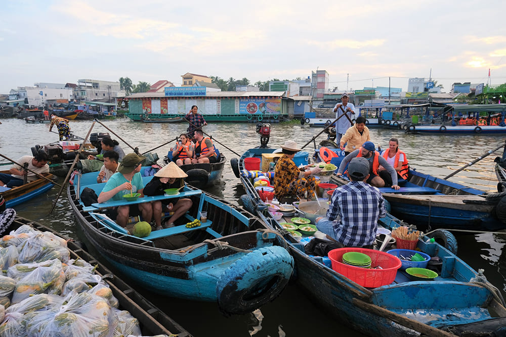 Digital nomads participating in communal meal in Mekong Delta